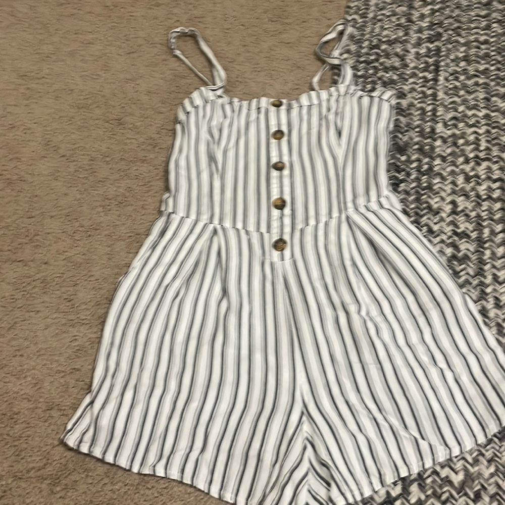 Gray and white striped Hollister romper with small stain on the back.